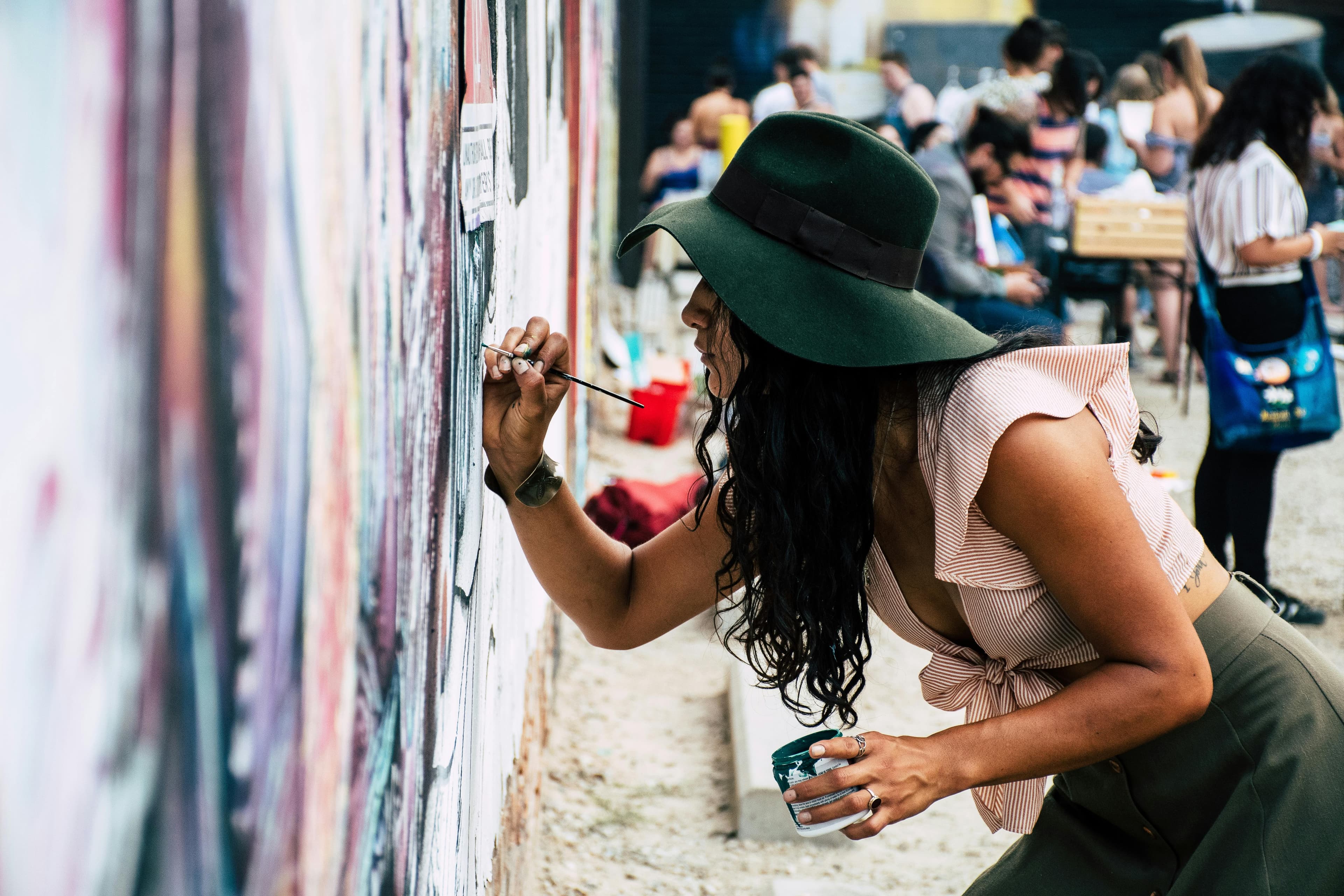Artist painting a large mural